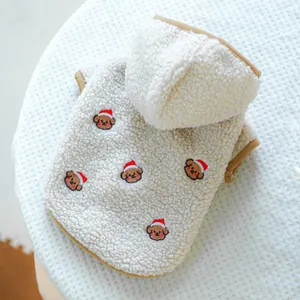 Close-up of soft sherpa fleece dog hoodie with festive bear embroidery and brown trim