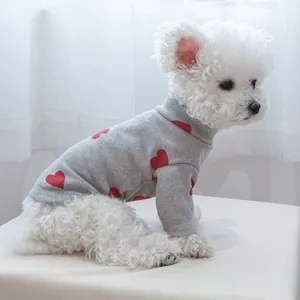 Grey turtleneck dog sweater with red hearts and ribbed texture on a white poodle