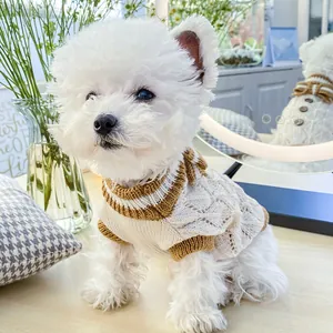 Detail of pet knit sweater with hollow-out pattern, brown bow, and striped trim