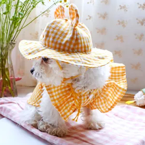 Close-up of a yellow plaid pet sun hat with rabbit ears and a matching lace capelet