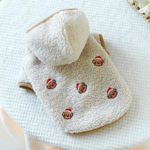Close-up of fluffy sherpa fleece pet hoodie featuring festive Christmas bear embroidery