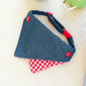 Close-up of denim pet bandana with adjustable red buckle and stylish red button detail
