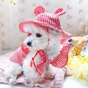 Detail of red gingham pet sun hat with cute ears and matching ruffled cape set