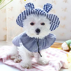 Close-up of blue plaid pet sun hat with cute ears and matching adjustable bib for small dogs