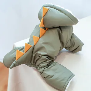 Detail view of dinosaur pet coat showing quilted green fabric and warm fleece lining