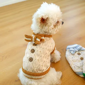 Detailed knit texture of a dog sweater featuring wooden buttons and a striped bow tie
