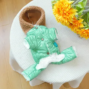 Detailed close-up of thick green polka dot pet coat with warm fleece lining and hood