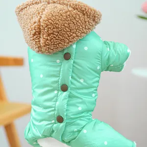 Detail of mint green polka dot dog coat with plush brown sherpa collar and button closures