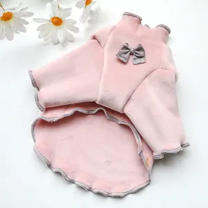 Detail of pink coral fleece pet shirt with a grey bow and wavy stitching