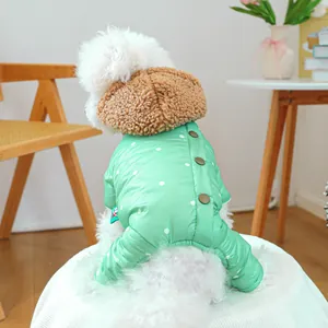 Detail of green polka dot winter pet coat with warm brown fleece hood and snap buttons