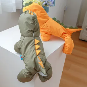 Detail view of windproof quilted dinosaur pet winter coats in green and orange colors