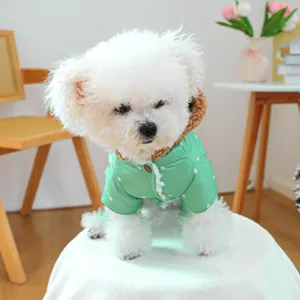 Detail of mint green polka dot dog coat with brown fleece collar and lace trim