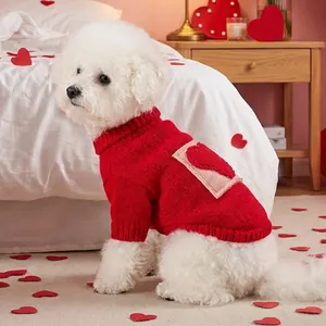 Red knit pet sweater with heart patch on white dog in cozy home festive setting