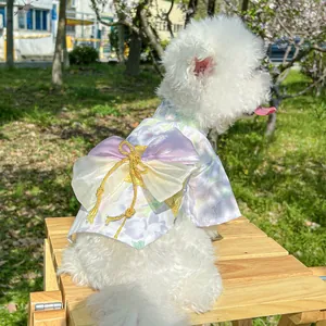 Detail of pet floral kimono dress with a large decorative bow and gold tassel accents