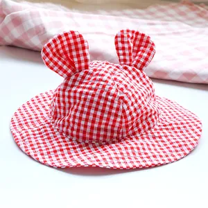 Close-up of red and white gingham sun hat for pets with cute rabbit ears and wide brim