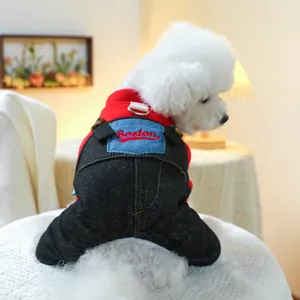 Detail of red hoodie and denim overalls on a small dog with Boston embroidery and D-ring