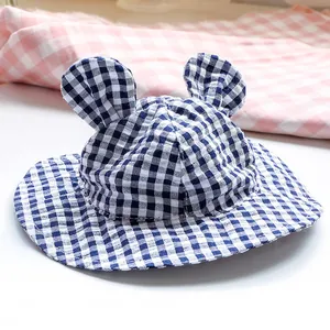 Detailed view of the blue gingham pet sun hat with cute 3D ears on a soft background