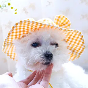 Detailed view of yellow plaid pet sun hat with wavy wide brim and tie for small dogs