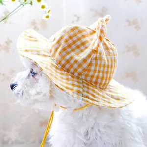 Close-up of yellow gingham dog sun hat with cute ears and adjustable drawstring strap