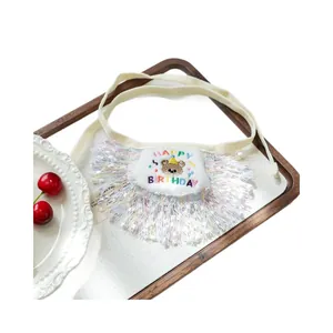 Dog birthday bib with rainbow tassels and colorful Happy Birthday embroidery on wood