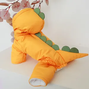 Detail of yellow dinosaur pet coat showing green fins and warm white fleece lining