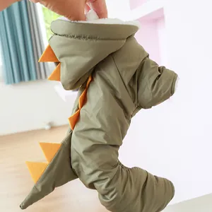 Detail of green dinosaur pet winter coat with orange spikes and warm plush lining