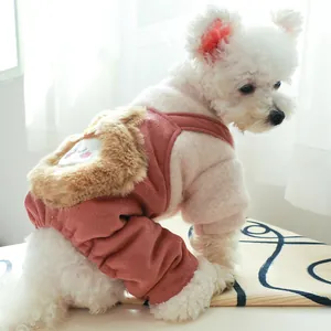 Detail of warm pink fleece dog jumpsuit with cute teddy bear patch and white faux fur trim