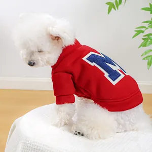 Close-up of red fleece dog sweatshirt with blue letter M embroidery and ribbed cuffs