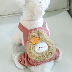 Close-up of pink fleece pet dog clothes with a 3D plush bear head and flower detail