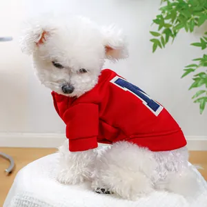 Detail of red fleece pet sweatshirt with white and blue letter M logo on back