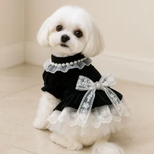 Elegant velvet dog dress with pearl collar, lace bow, and multilayered tulle tutu skirt