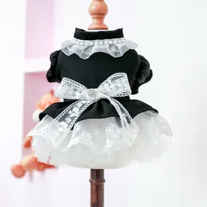 Detailed view of pet dress featuring pearl collar, lace bow, and velvet texture on mannequin