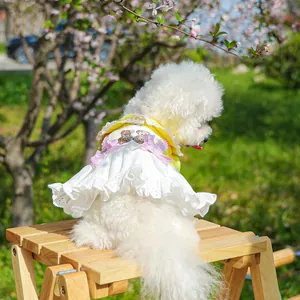 Detailed embroidery of bear and pink bows on a white lace pet dress for dogs