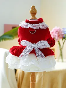 Detailed view of red velvet pet dress with pearl collar and multi-layer lace skirt