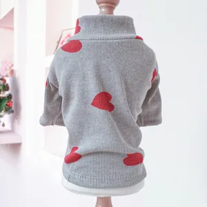 Detail of grey ribbed knit pet sweater with red heart patterns on a pet display stand