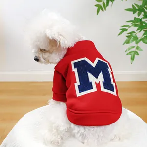 Close-up of red pet sweatshirt with blue letter M embroidery on soft fleece fabric