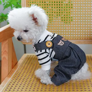 Detail of dog denim overalls with bear embroidery and striped long sleeve shirt on a small dog
