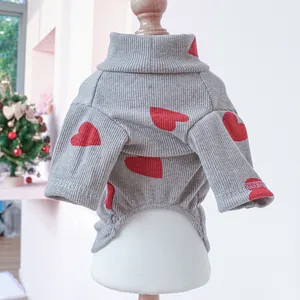 Close-up of gray ribbed pet sweater with red heart patterns on a display stand