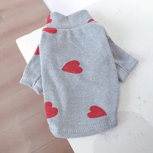 Close-up of ribbed knit pet sweater featuring a red heart pattern on gray fabric