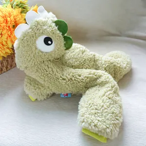 Detail of plush dinosaur pet hoodie featuring soft green fleece fabric and cartoon eyes
