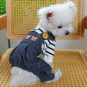 Close-up of dog denim overalls with bear embroidery and striped shirt on small dog