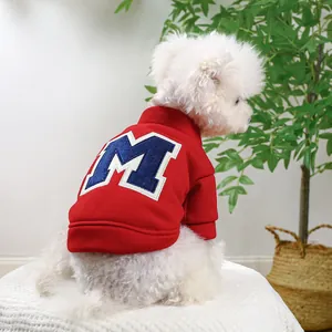 Close-up of red dog hoodie with plush letter M embroidery on soft cotton fabric
