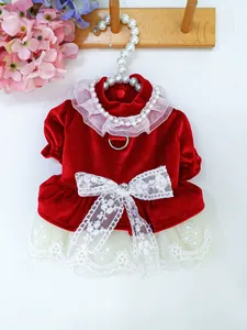 Detail of red velvet pet dress with white lace bow and metal D-ring for leash