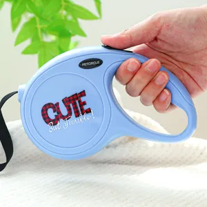 Gros plan d'une laisse rétractable bleue pour chien avec poignée ergonomique et texte