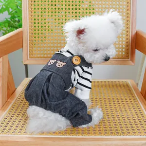Striped shirt and bear embroidered denim overalls for dogs on a rustic chair
