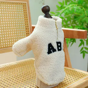 Detail of pet fleece vest with zipper neck and embroidered letters on a wooden model