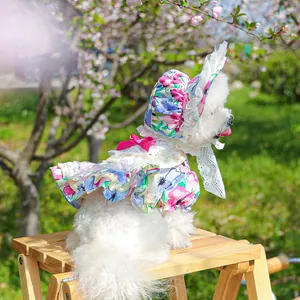 Floral pet dress with matching sun hat and lace layers for small dogs shown on wooden ladder