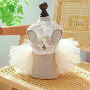 Elegant off-white lace pet dress with multi-layer tutu skirt on a wooden mannequin