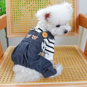 Detail of pet denim overalls with bear embroidery and stripe shirt on a small dog