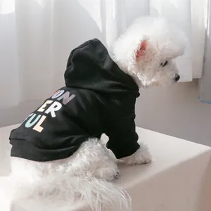 Detail of black pet hoodie with colorful letter print on soft cotton fabric for dogs